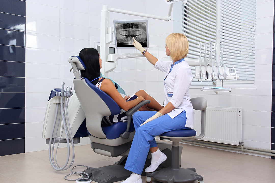 Dentist hand examining patient's teeth X Ray
